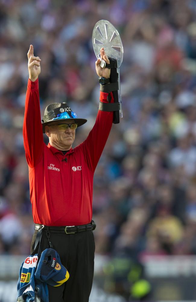 Bruce Oxenford signals a six using his special arm guard. AFP photo: Jon Super