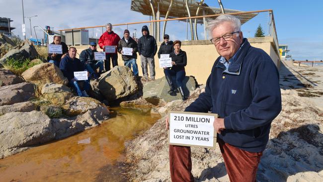 Western Adelaide Coastal Residents Association members Chris Schultz, Theo Ellenbroek, Jim Douglas, Peter Schultz, Fernando Smith, Bert Brown, Kenzie van den Nieuwelaar and Anne Wheaton at the Henley Beach drain. Picture: AAP / Brenton Edwards