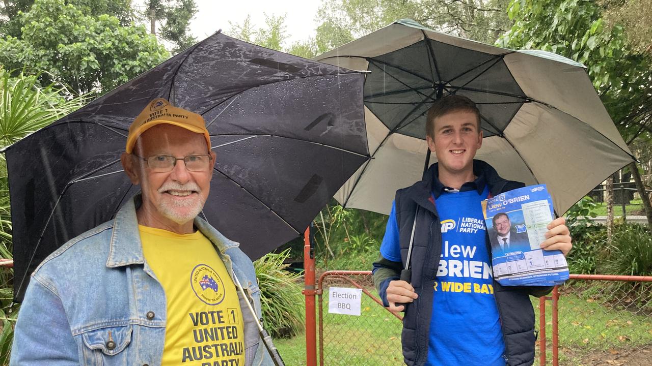 Peter Hardy and Hayden Pratt endure continual rain in the name of democracy at the Monkland State School election booth in Gympie on Saturday.