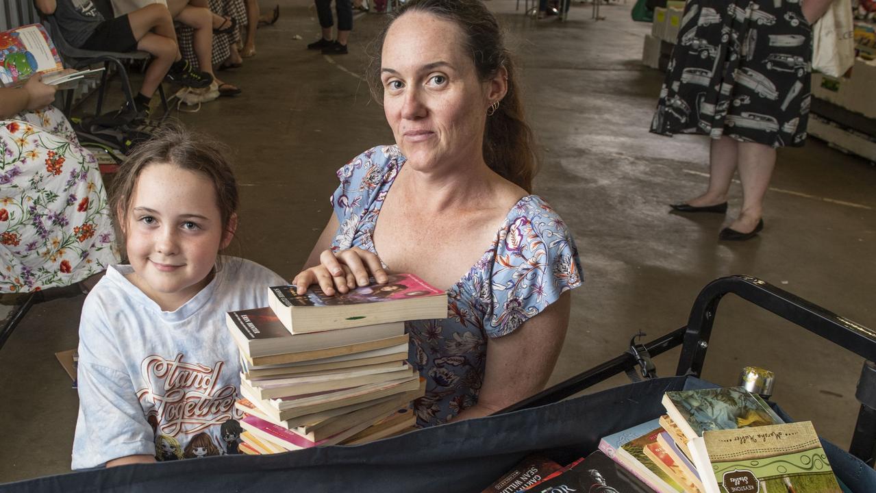 Avid mum and daughter readers Sharla and Zara Straker (left) of Westbrook soon filled their trolley with bargain books. The Chronicle Lifeline BookFest at Toowoomba Showgrounds. Saturday, March 4, 2023. Picture: Nev Madsen.