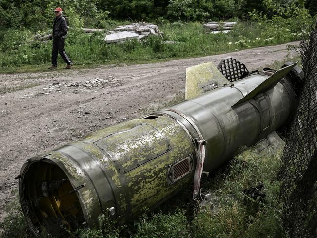 A man walks near the remains of a missile in the city of Lysychansk. Picture: AFP