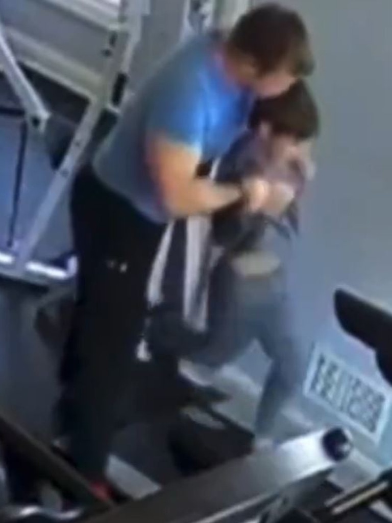 Christopher Gregor appears to bite his son’s head as he places the child on a fast-moving treadmill on March 20, 2021.