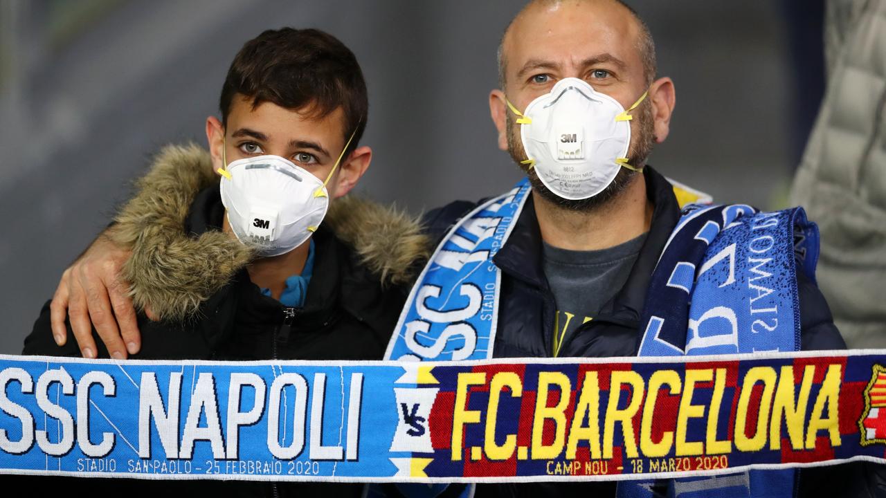 Fans wear medical face masks as they await kick off prior to the UEFA Champions League round of 16 first leg match between SSC Napoli and FC Barcelona at Stadio San Paolo on February 25, 2020 in Naples, Italy. Picture: Michael Steele/Getty Images