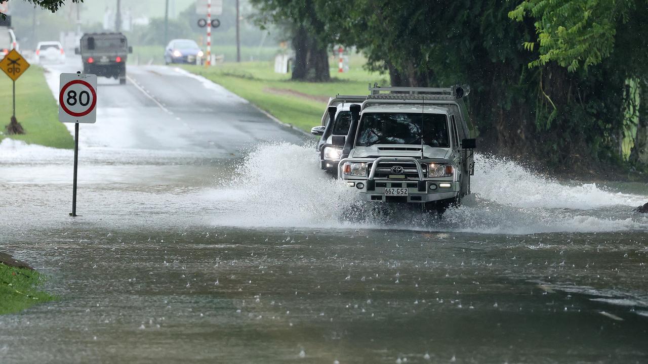 Four-wheel drive vehicles driving through water over the road at Foxton Bridge in Mossman. Picture: Liam Kidston