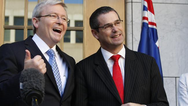 Kevin Rudd and Stephen Conroy laugh during a press conference at Parliament House in Canberra.