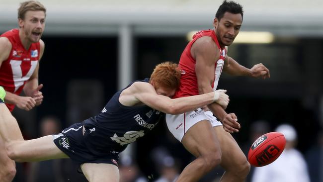 North Adelaide’s Marlon Motlop tackled by South Adelaide’s Joseph Haines.