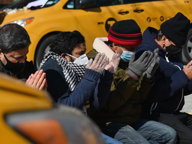 Yellow cab drivers pray before joining a rally in New York City calling for debt forgiveness for loss of income amid work shortage due to coronavirus. Picture: AFP