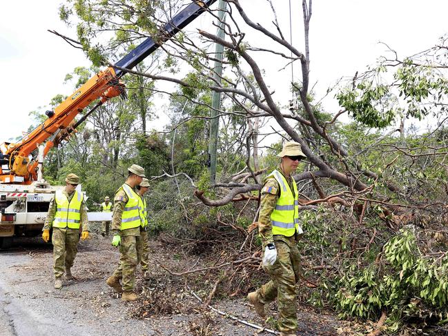 ADF help in the clean up at Kriedeman Road in Wongawallan after ferocious storms dame the Gold Coast area. Pics Adam Head