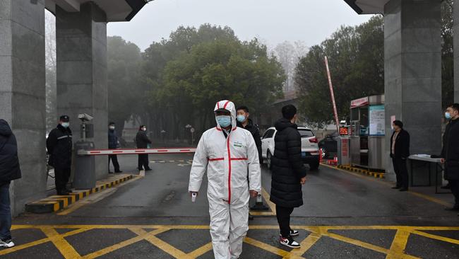 A guard wearing a protective gear is seen at the entrance of the Hubei provincial centre for disease control and prevention as members of the WHO team investigating the origins of the Covid-19 coronavirus, visit. Picture: AFP