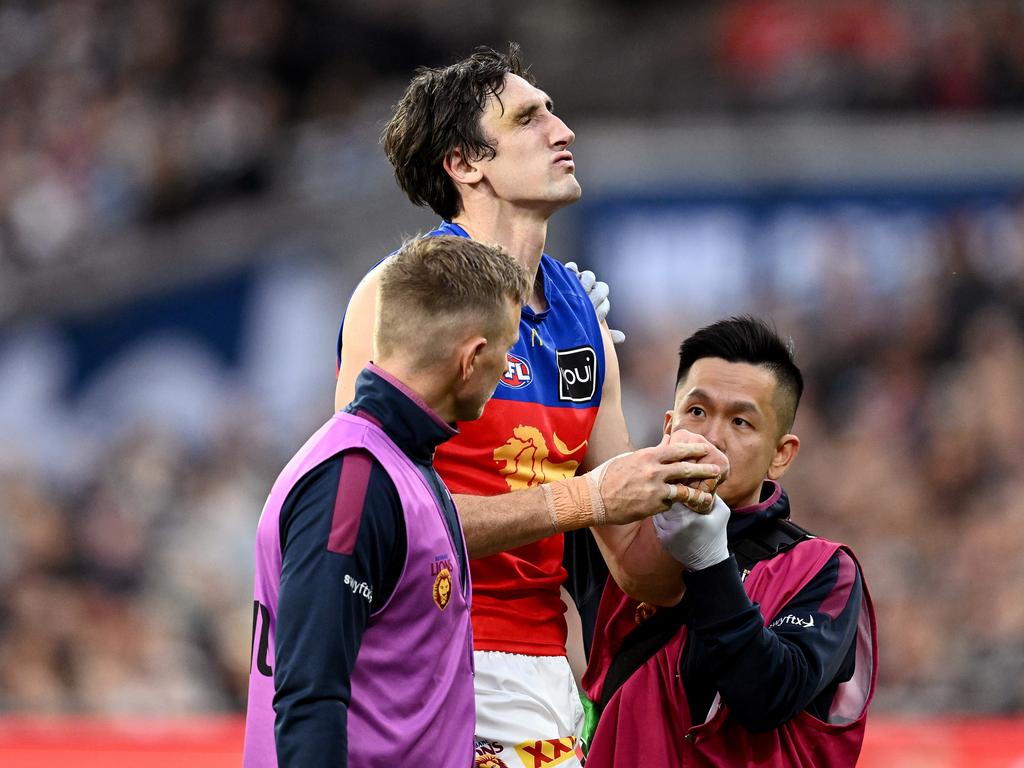 Oscar McInerney being helped from the field in the first quarter. Picture: Quinn Rooney/Getty Images.