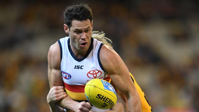 Sam Gibson gets a handball away while playing for the Crows. Picture: AAP Image/Julian Smith.