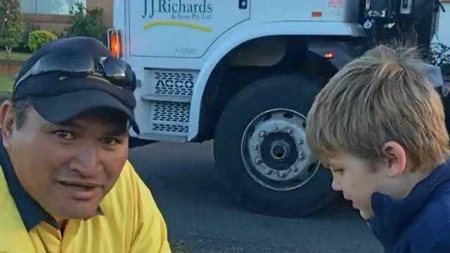 JJ Richards truck driver Ngamata-o-apii Tini presents Carter with a toy garbage bins.