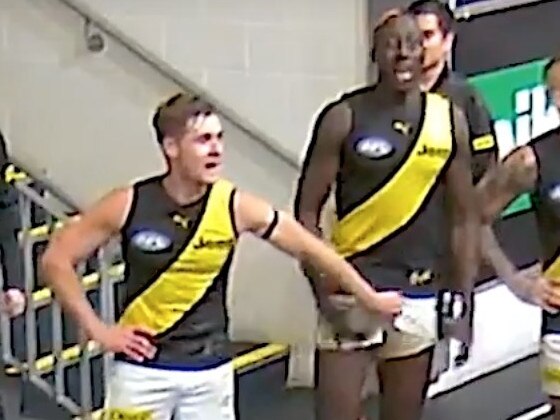 Richmond players are seen groping Mabior Chol during team song in the rooms.
