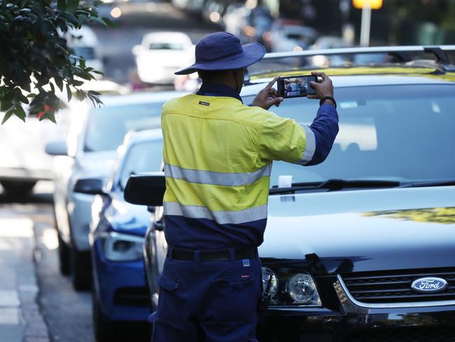 Parking Inspector Vaseem Akram in the city he wa shappy to be photographed going about his job. Pic Annette Dew