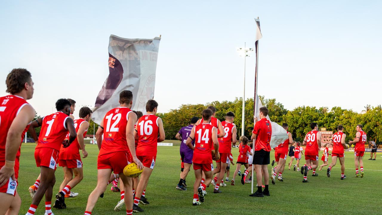 The Waratahs pay tribute to late, great ruckman Alexander ‘Rooch’ Aurrichio at the first game under lights at Gardens Oval. Picture: Aaron Black/AFLNT Media