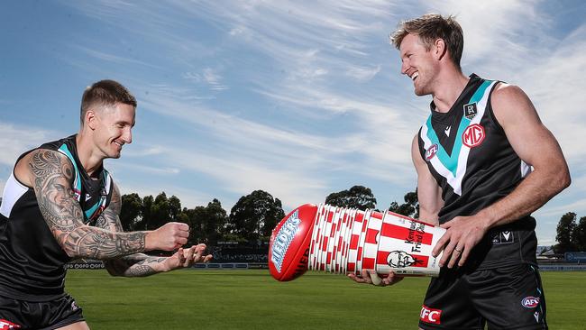 Port Adelaide’s Hamish Hartlett and Tom Jonas with the club’s new major sponsor, KFC. Picture: Sarah Reed