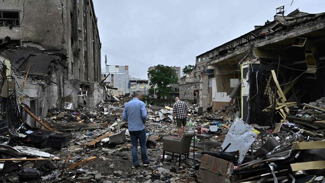 Local residents walk among debris following a Russian missile strike in the centre of Kramatorsk.