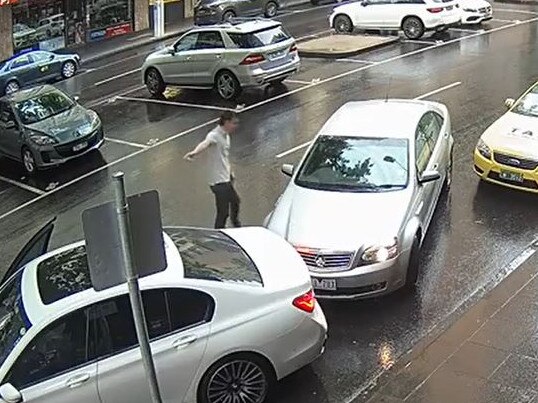Porsche driver Richard Pusey raises his arms in CCTV footage aired in court on Thursday.