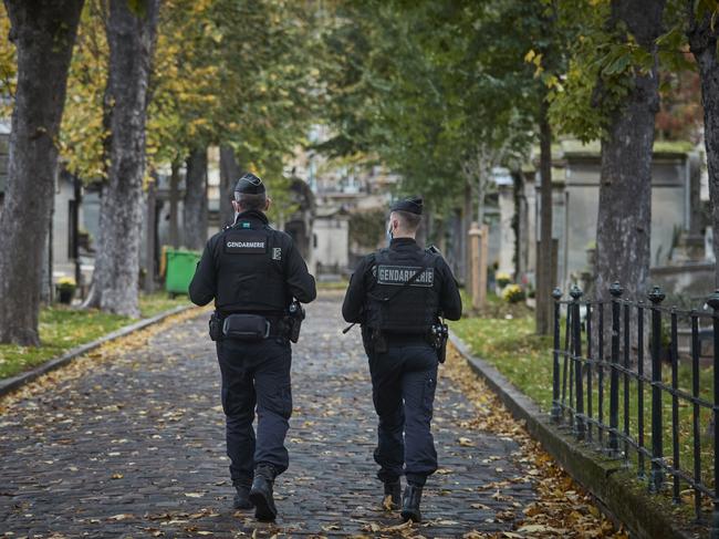 Armed French Police patrol inside the Cemetery of Montmartre on All Saints Day in Paris, France. Picture: Getty Images