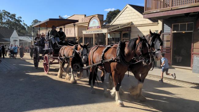 A horse-drawn carriage brings visitors through Sovereign Hill.