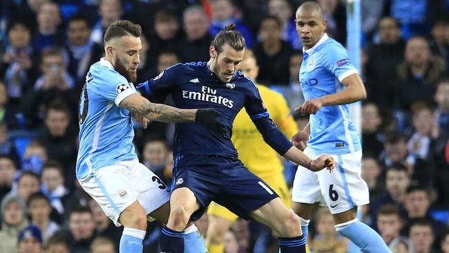 Real Madrid's Gareth Bale fights for the ball against Manchester City's Nicolas Otamendi.