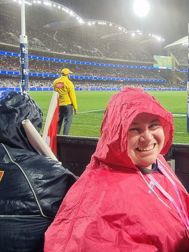 Chelsea Heath sitting in the rain with the Bulldogs cheer squad on Saturday night.