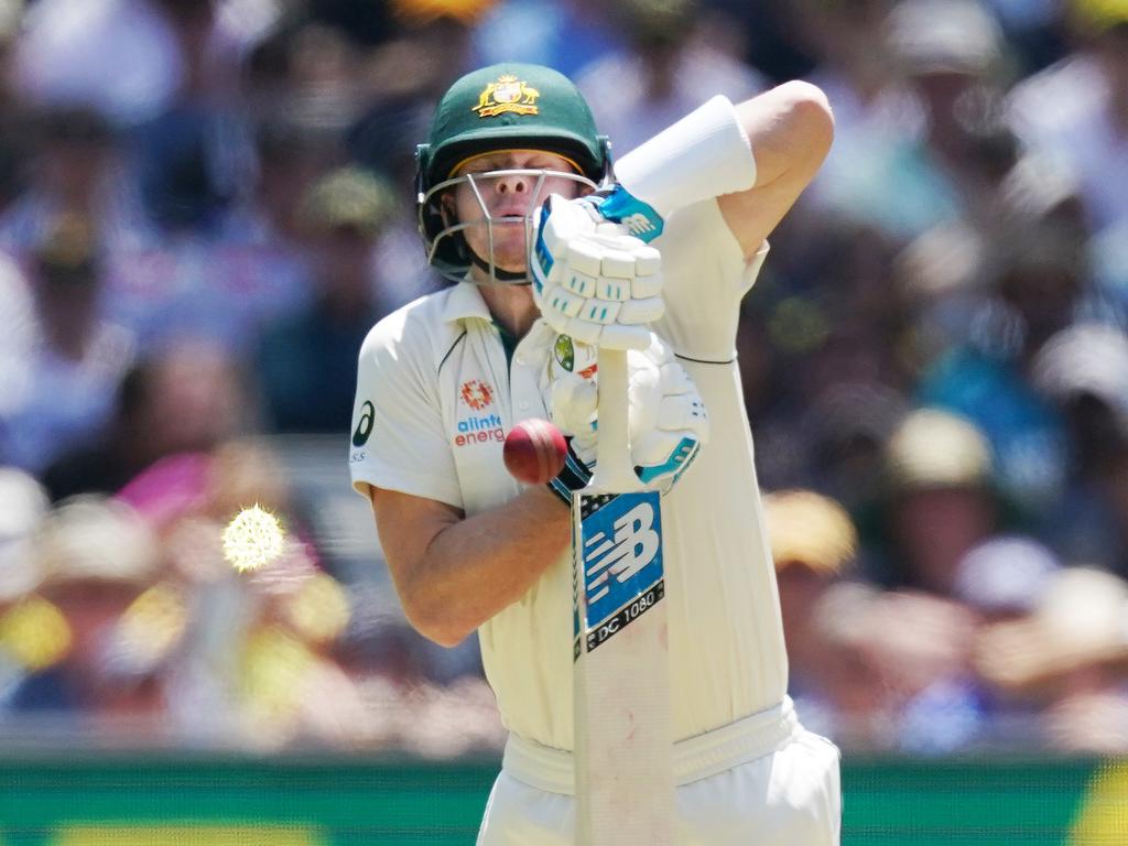 Steve Smith of Australia defends a bouncer.