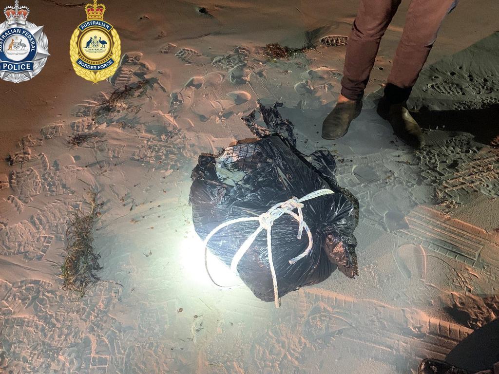 The black plastic-wrapped package allegedly containing multiple smaller packages of cocaine washed ashore.