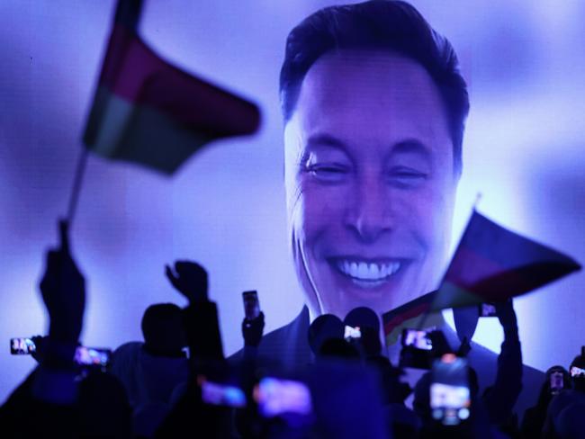 HALLE, GERMANY - JANUARY 25: Tech billionaire Elon Musk speaks live via a video transmission during the election campaign launch rally of the far-right Alternative for Germany (AfD) political party as AfD supporters wave German flags on January 25, 2025 in Halle, Germany. Musk is an outspoken supporter of the AfD and is urging German voters to cast their ballots for the party. The AfD is currently in second place in polls ahead of federal parliamentary snap elections scheduled for February 23. (Photo by Sean Gallup/Getty Images)