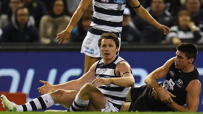 Patrick Dangerfield looks to the umpire after tackling Matthew Kreuzer. Picture: AAP