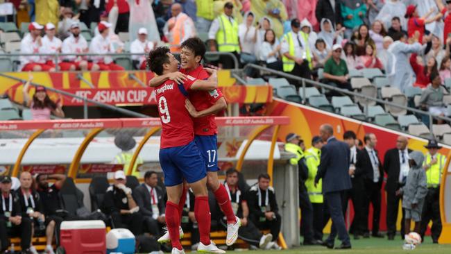 South Korea's Cho Young Cheol, left, celebrates with teammate Lee Chung Yong after scoring a goal during the first round soccer match of the AFC Asia Cup between Korea and Oman in Canberra, Australia, Saturday, January 10, 2015. (AP Photo/Andrew Taylor)