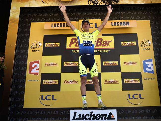 Stage winner Australia's Michael Rogers celebrates on the podium after winning the sixteenth stage.