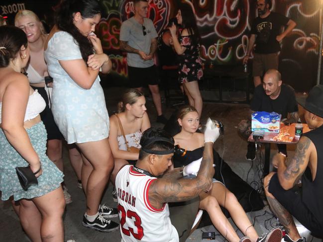 Hygiene has been thrown out the door for schoolies eager for a cheap tat in Bali. Picture: Lukman S. Bintoro