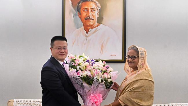 Chinese ambassador to Bangladesh Yao Wen congratulates Sheikh Hasina with a floral bouquet in Dhaka on Sunday. Picture: AFP