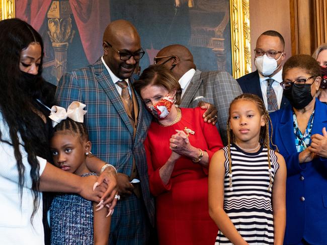 Philonise Floyd, the brother of George Floyd, puts his arm around House Speaker Nancy Pelosi, D-CA, as he and other members of the Floyd family meet with leaders in the Rayburn Room of the US Capitol in Washington, DC on May 25, 2021. (Photo by Bill Clark / POOL / AFP)