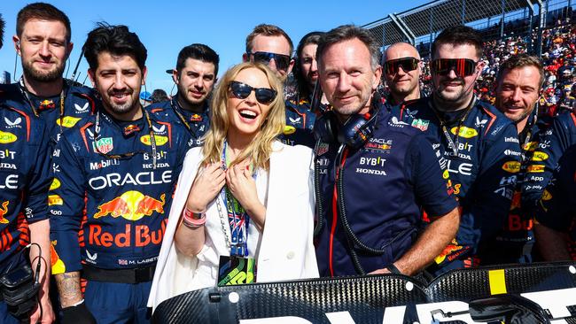 Kylie Minogue poses for a with the Red Bull Racing team at Albert Park. Picture: Mark Thompson/Getty Images