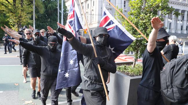 Pro and anti immigration protesters gather in Spring st in Melbourne. Far right activist give the Nazi salute. Picture: NCA NewsWire / David Crosling