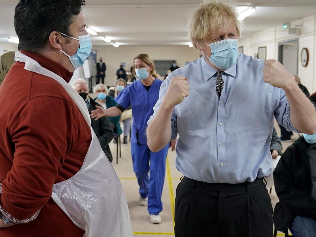 Britain's Prime Minister Boris Johnson talks to fellow former COVID patient Christopher Nicholls at the Al-Hikmah Vaccination Centre in Batley, northern England, on February 1. Picture: Jon Super / POOL / AFP