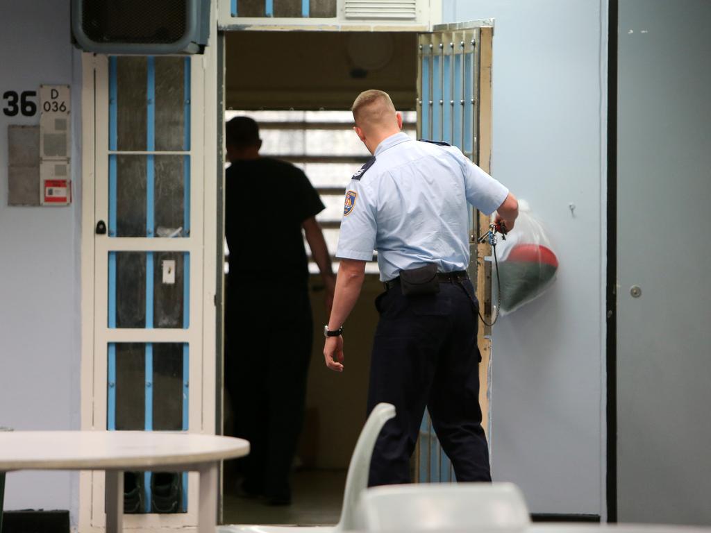 A Correctional Services officer puts an inmate back in his cell at Silverwater Correction Centre. Picture: Tim Hunter