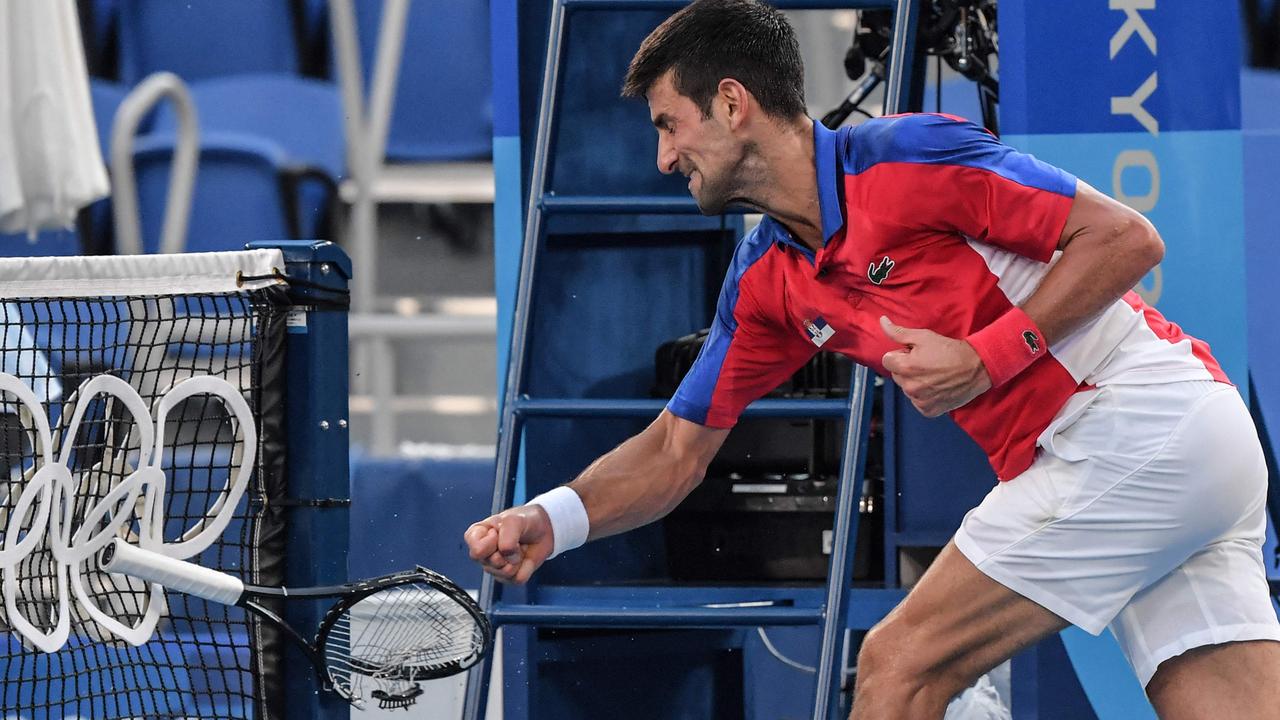 Serbia's Novak Djokovic smashes his racket. (Photo by Tiziana FABI / AFP)