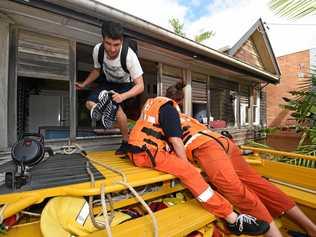 SES crews search and rescue people who were stranded in the houses in North Lismore in 2017. Picture: Marc Stapelberg