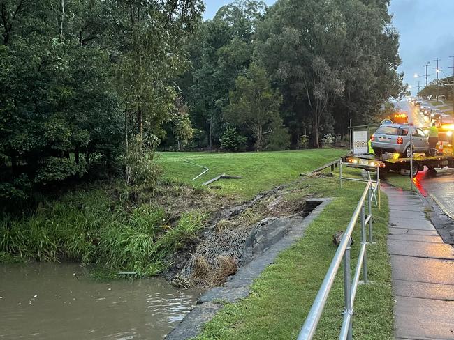 A car is pulled from floodwaters at Chermside West on Friday afternoon, but no one was reported hurt or missing.