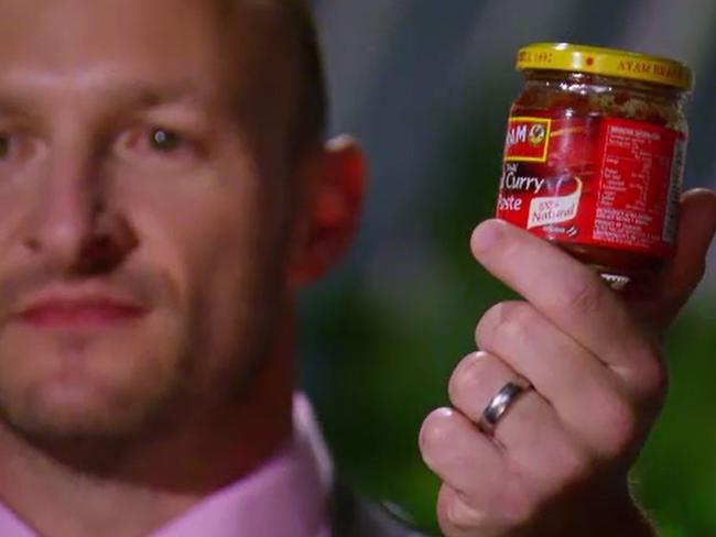 Matt Jenner shows his MKR rivals the curry paste he and Alyse used. Picture: Channel 7
