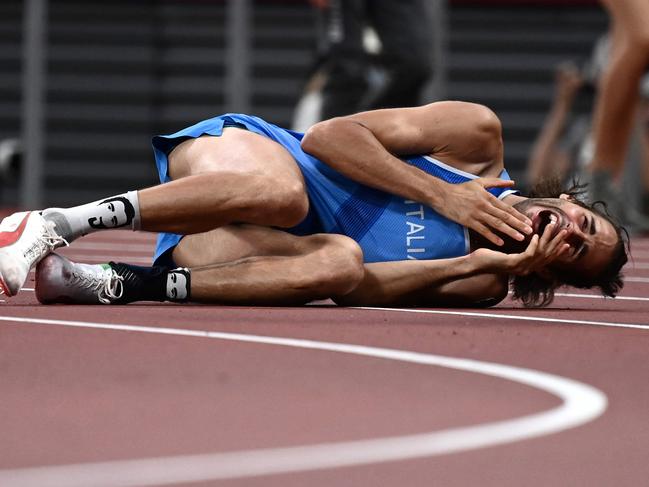 Italy's Gianmarco Tamberi reacts as he competes in the men's high jump final during the Tokyo 2020 Olympic Games at the Olympic Stadium in Tokyo on August 1, 2021. (Photo by Jewel SAMAD / AFP)