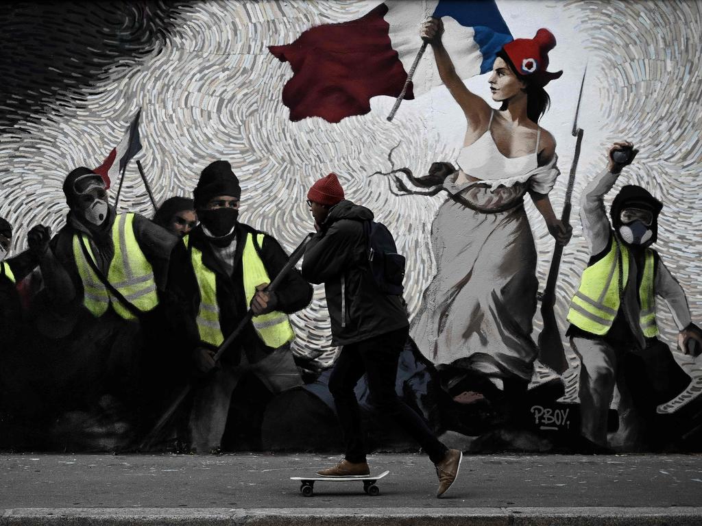 A mural by street artist PBOY depicting yellow vest protesters inspired by Delacroix’s painting <span id="U643724138152lqF" style="font-weight:normal;font-style:italic;">Liberty Leading the People</span>. Picture: Philippe Lopez/AFP