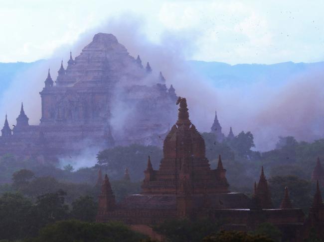 The ancient Dhammayangyi temple is seen shrouded in dust as a 6.8 magnitude earthquake hit Bagan on August 24, 2016. A powerful 6.8 magnitude earthquake struck central Myanmar on August 24, killing at least one person and damaging pagodas in the ancient city of Bagan, officials said. The quake, which the US Geological Survey said hit at a depth of 84 kilometres (52 miles), was also felt across neighbouring Thailand, India and Bangladesh, sending panicked residents rushing onto the streets. / AFP PHOTO / SOE MOE AUNG