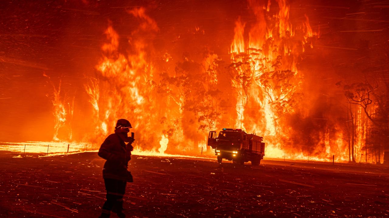 A fire erupts from bushland southwest of Sydney at the Green Wattle Creek, forcing the firefighters from Fire and Rescue NSW to flee and abandon their fire truck. Picture: Matthew Abbott/Panos Pictures for The New York Times