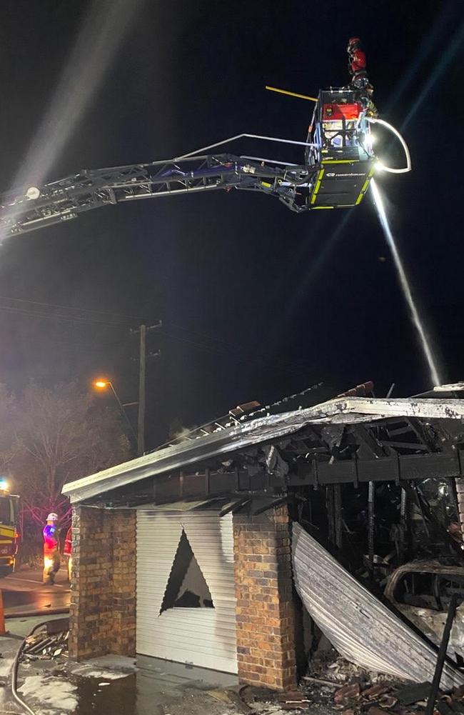 A special pumping truck with a large ladder is used to put out the fire at Mt Warren Park last night.