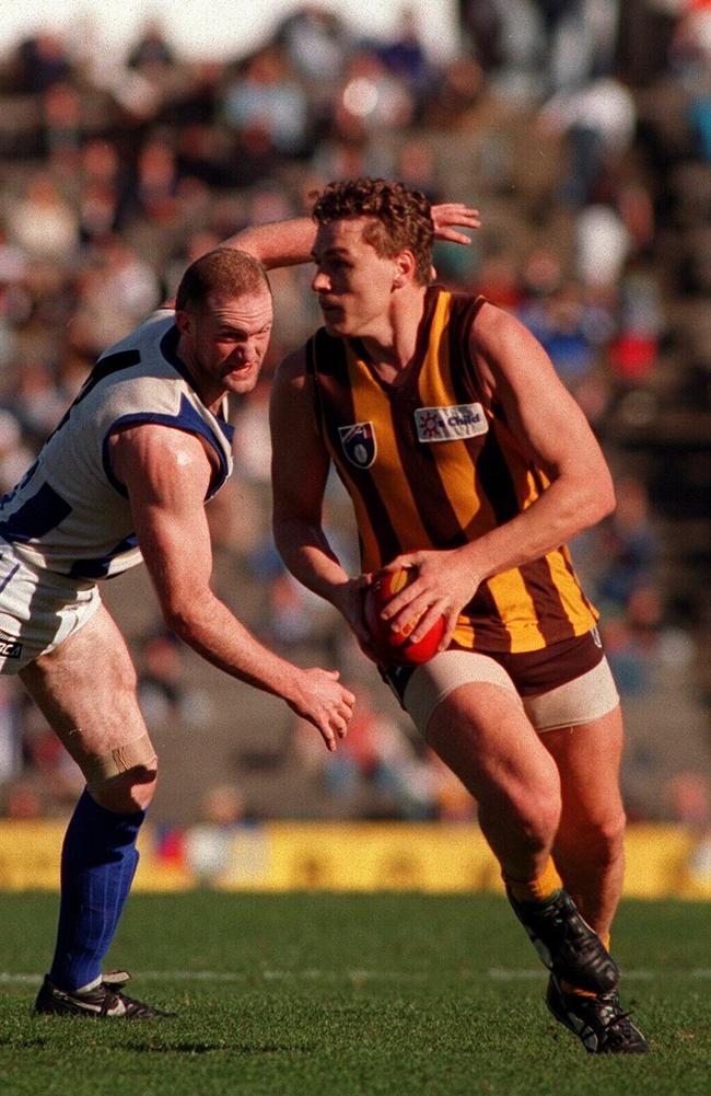 Dear gets past his North Melbourne opponent in 1996.