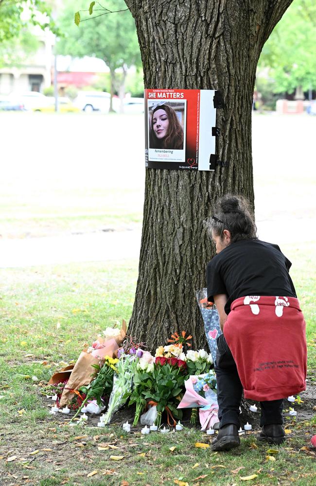 A woman lays flowers at the vigil. Picture: Josie Hayden